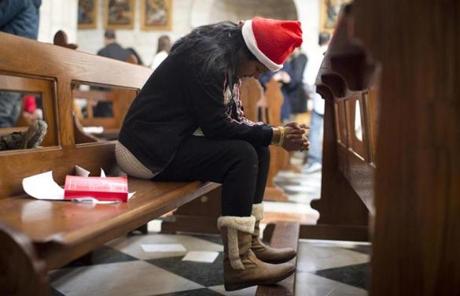 A worshipper in a Santa hat prayed during the Christmas mass at the Church of the Nativity.
